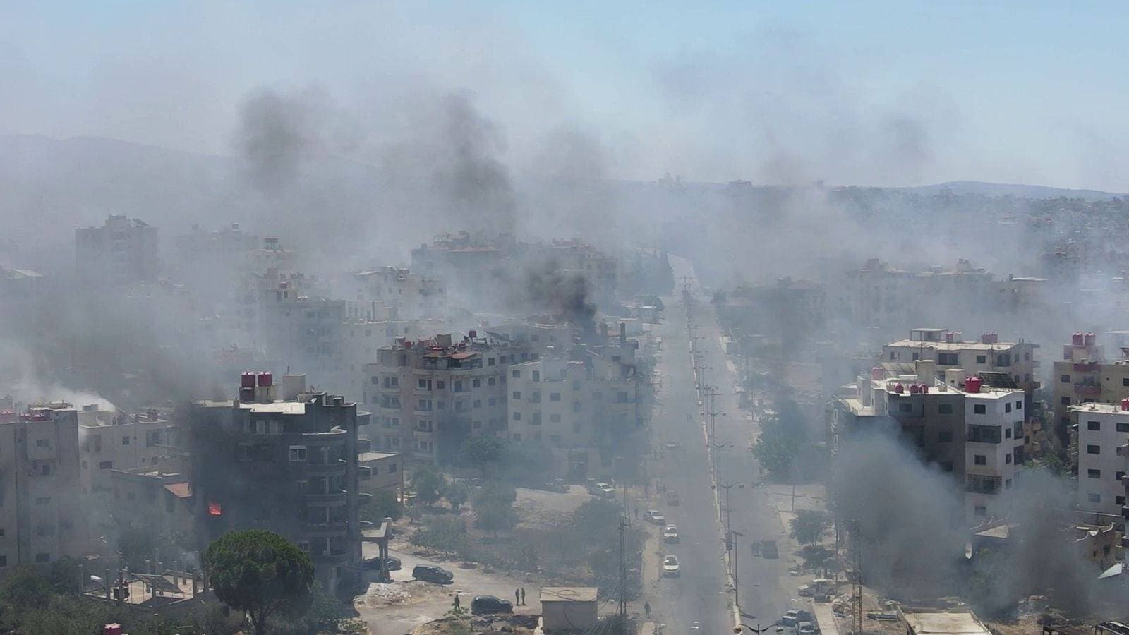 Homes still burning after mass pillaging and 30,000 trapped in besieged city as Syria’s fragile ceasefire holds