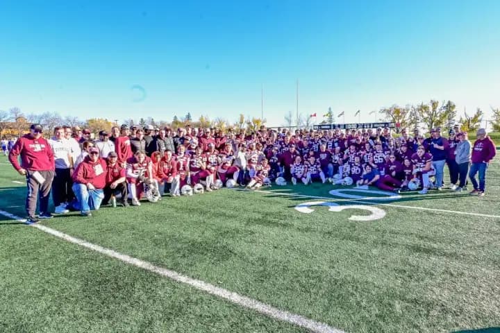Regina Thunder receives Prairie Football Conference trophy from Saskatoon Hilltops